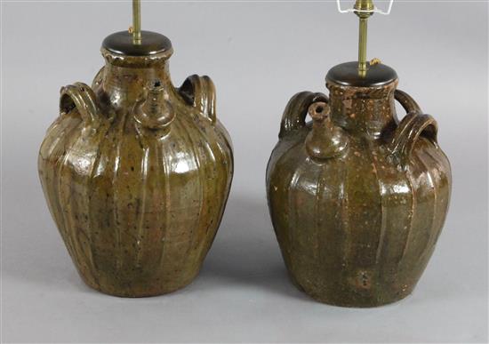 Two similar 17th century French, Auvergne, terracotta spouted jars, 14in. and 15.5in.